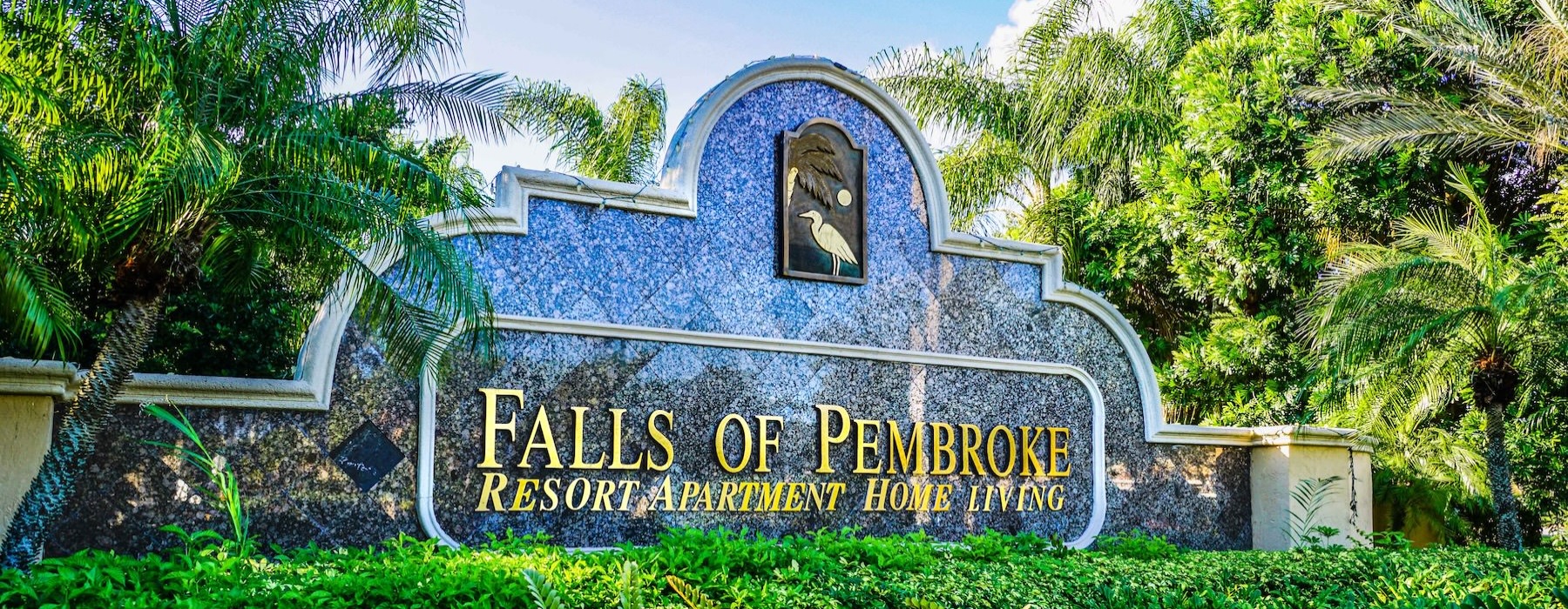 a sign surrounded but trees and bushes