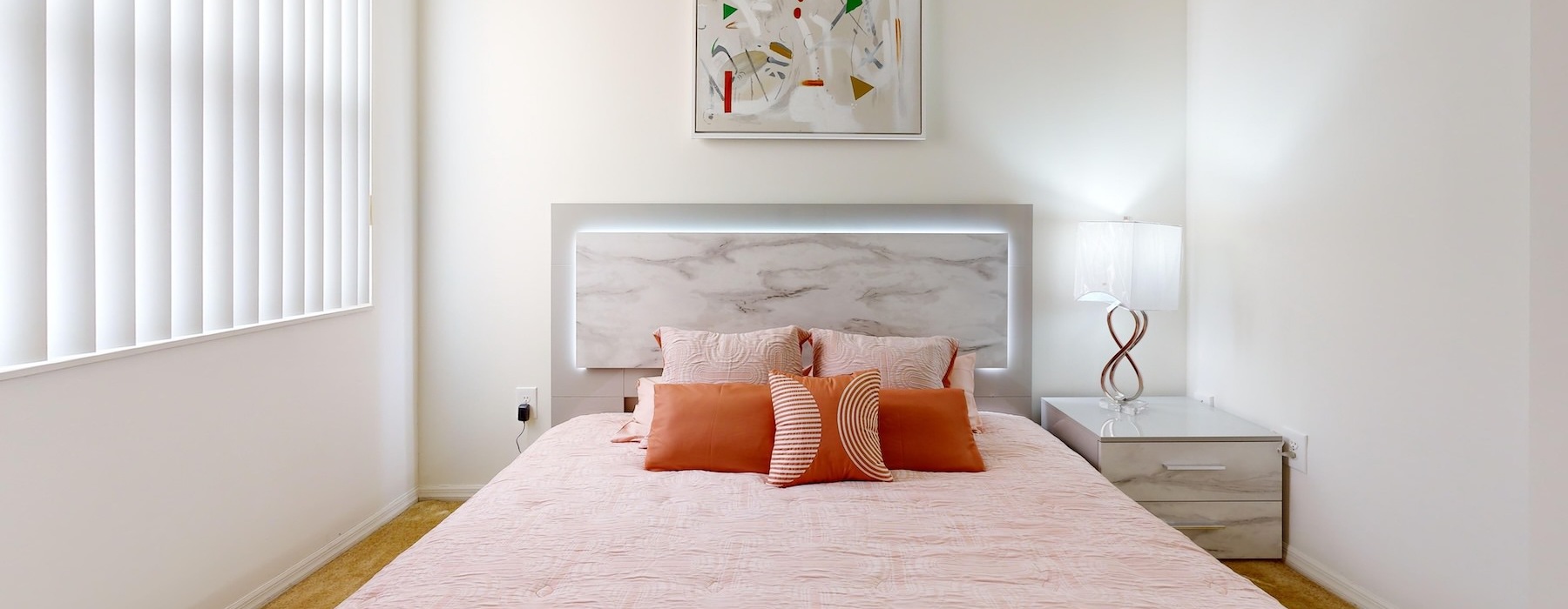 a bed with orange pillows